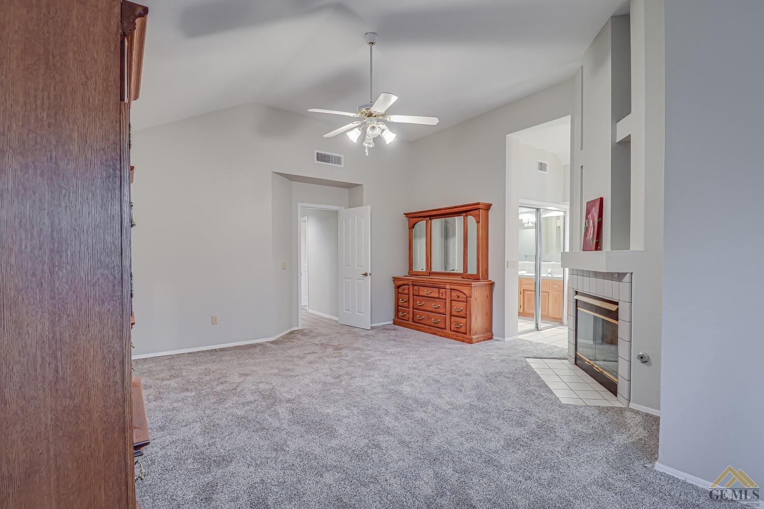 Undisclosed Address Bakersfield, CA 93314 - Photo 27 of 38 a view of a livingroom with furniture chandelier fan and a fireplace