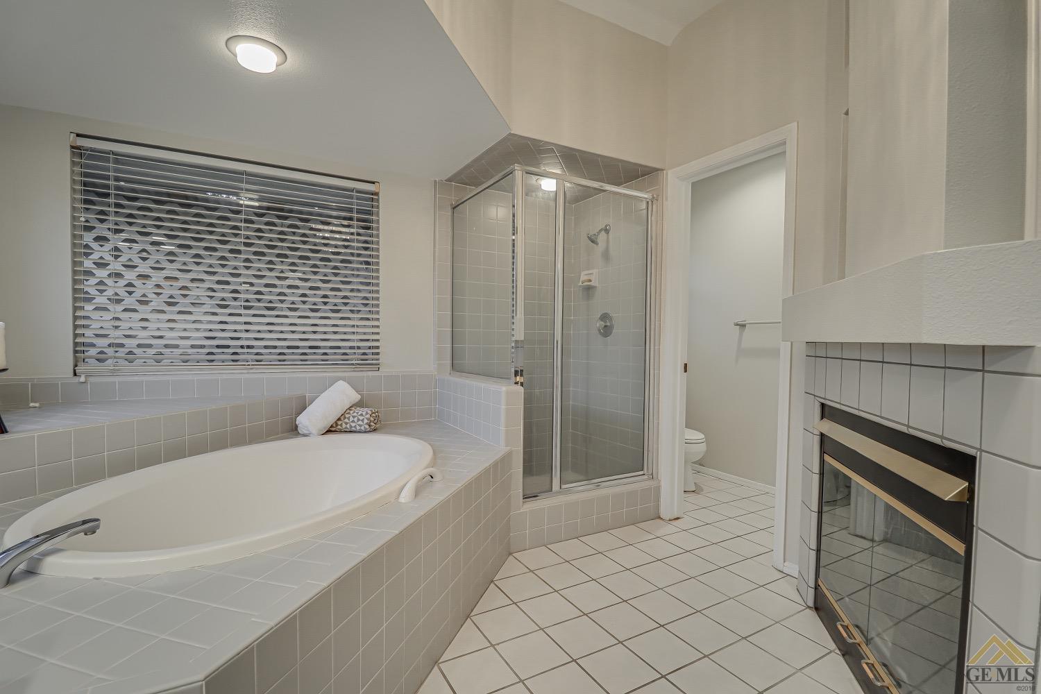 Undisclosed Address Bakersfield, CA 93314 - Photo 29 of 38 a spacious bathroom with a bathtub and shower