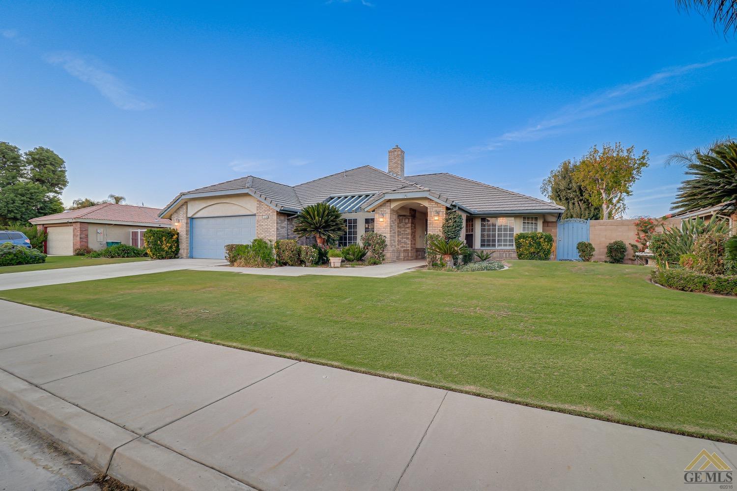 Undisclosed Address Bakersfield, CA 93314 - Photo 3 of 38 a front view of a house with a garden
