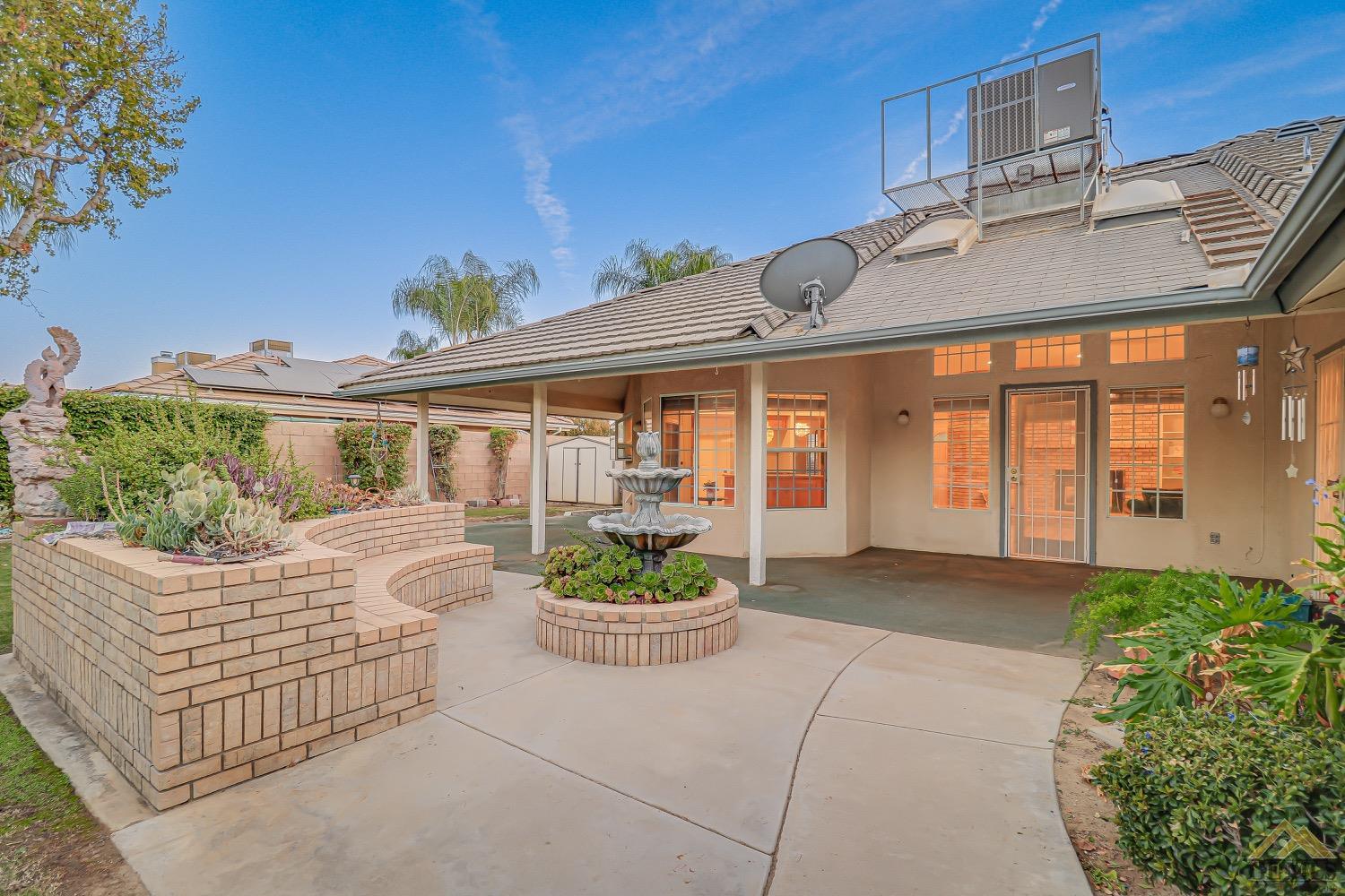 Undisclosed Address Bakersfield, CA 93314 - Photo 32 of 38 a front view of a house with a garden and plants