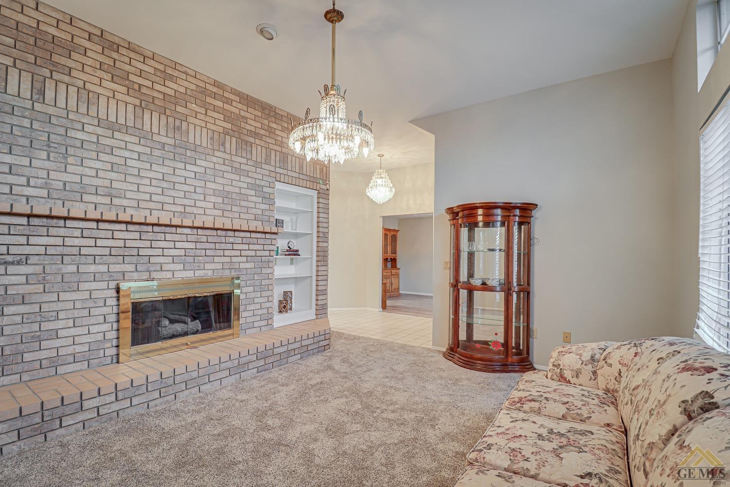 Undisclosed Address Bakersfield, CA 93314 - Photo 7 of 38 a bedroom with bed and a fireplace