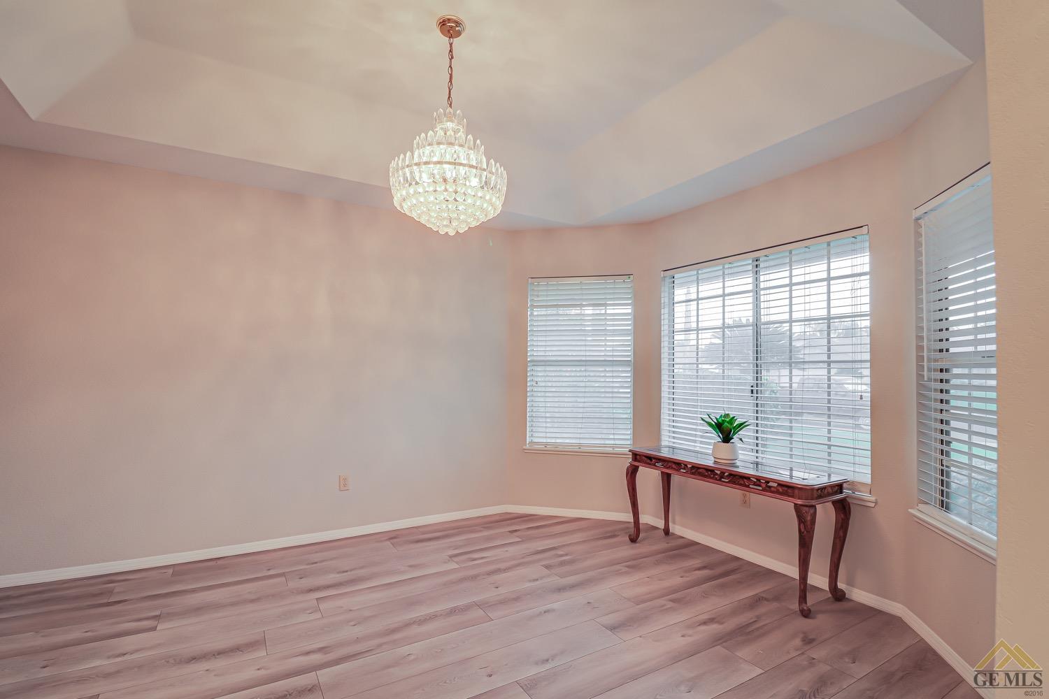 Undisclosed Address Bakersfield, CA 93314 - Photo 9 of 38 a view of an empty room with wooden floor and a window