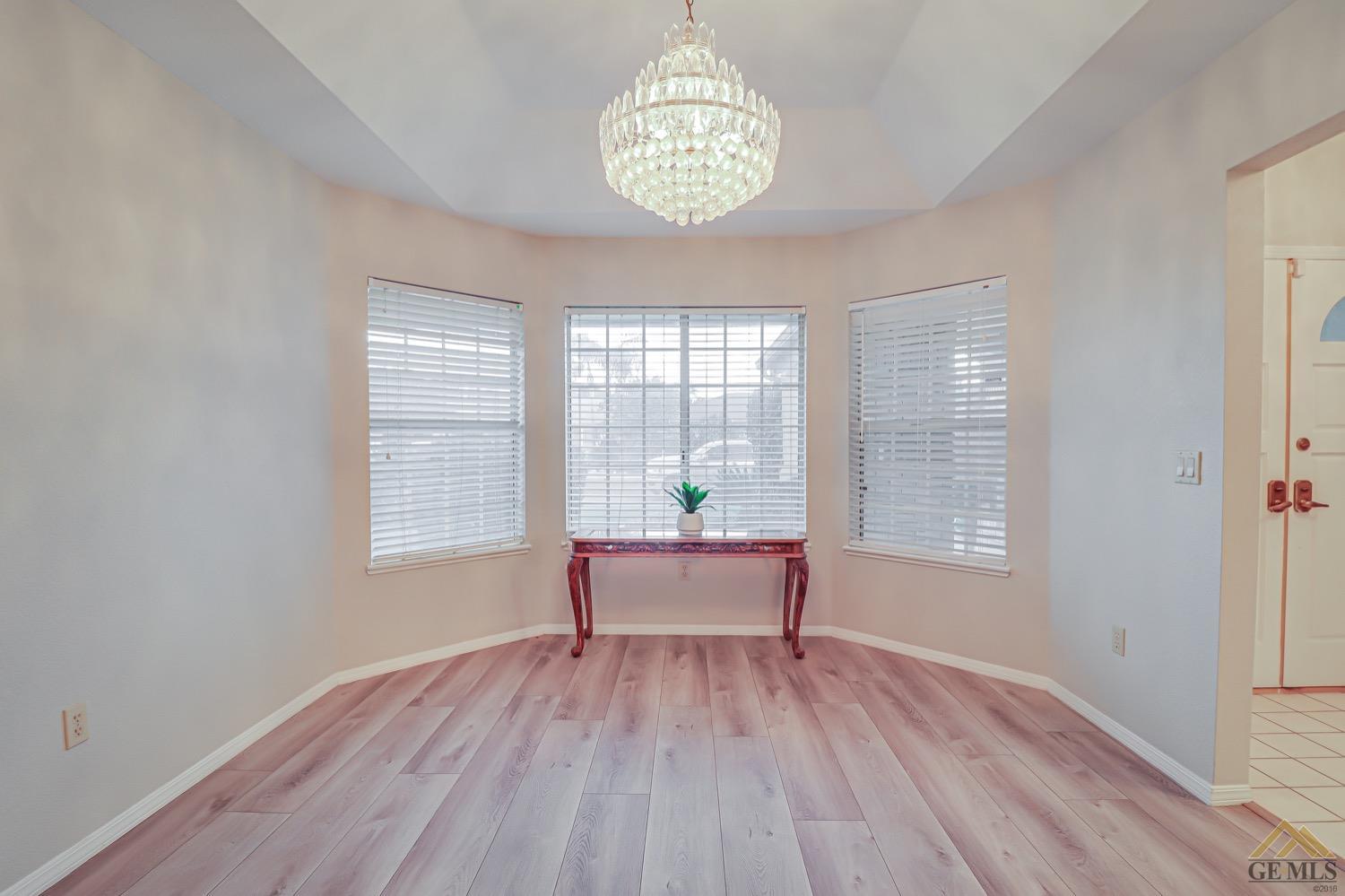 Undisclosed Address Bakersfield, CA 93314 - Photo 10 of 38 an empty room with wooden floor and windows