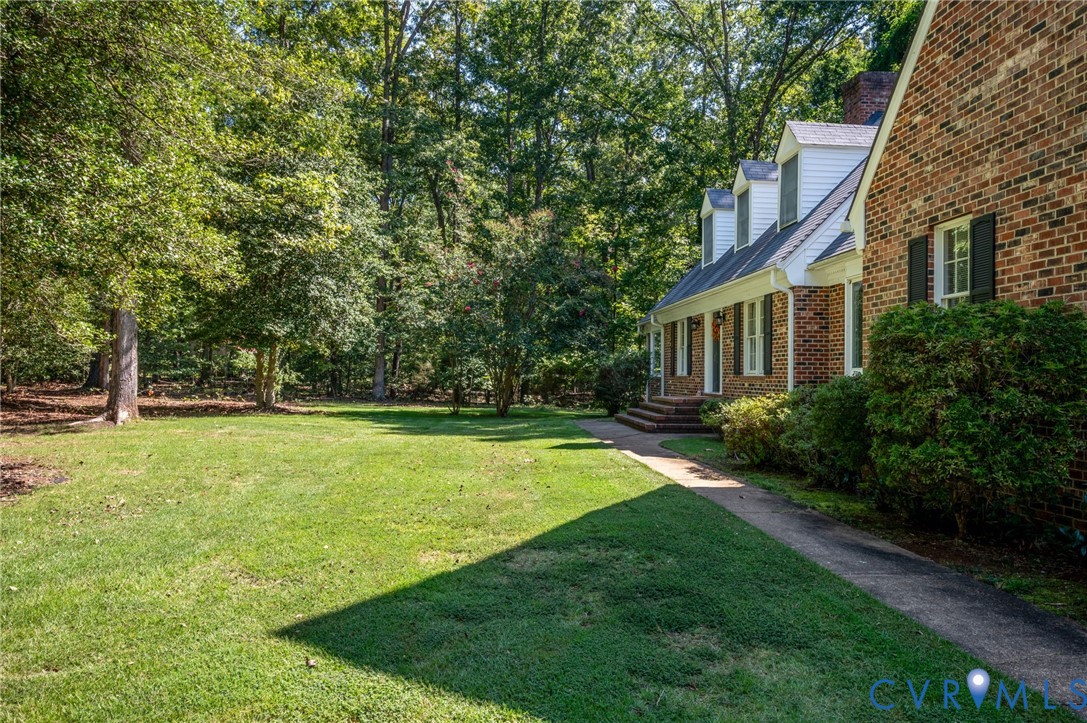 2409 Three Bridge Road Powhatan, VA 23139 - Photo 2 of 39 Brick exterior with dormer windows, covered front