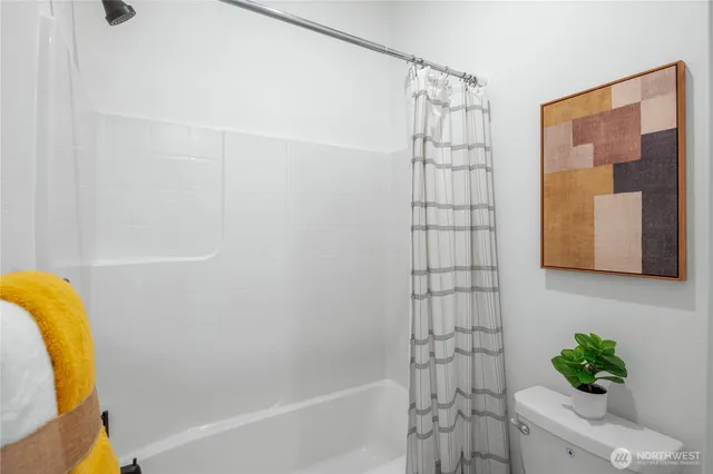 a bathroom with a shower curtain and a bathtub