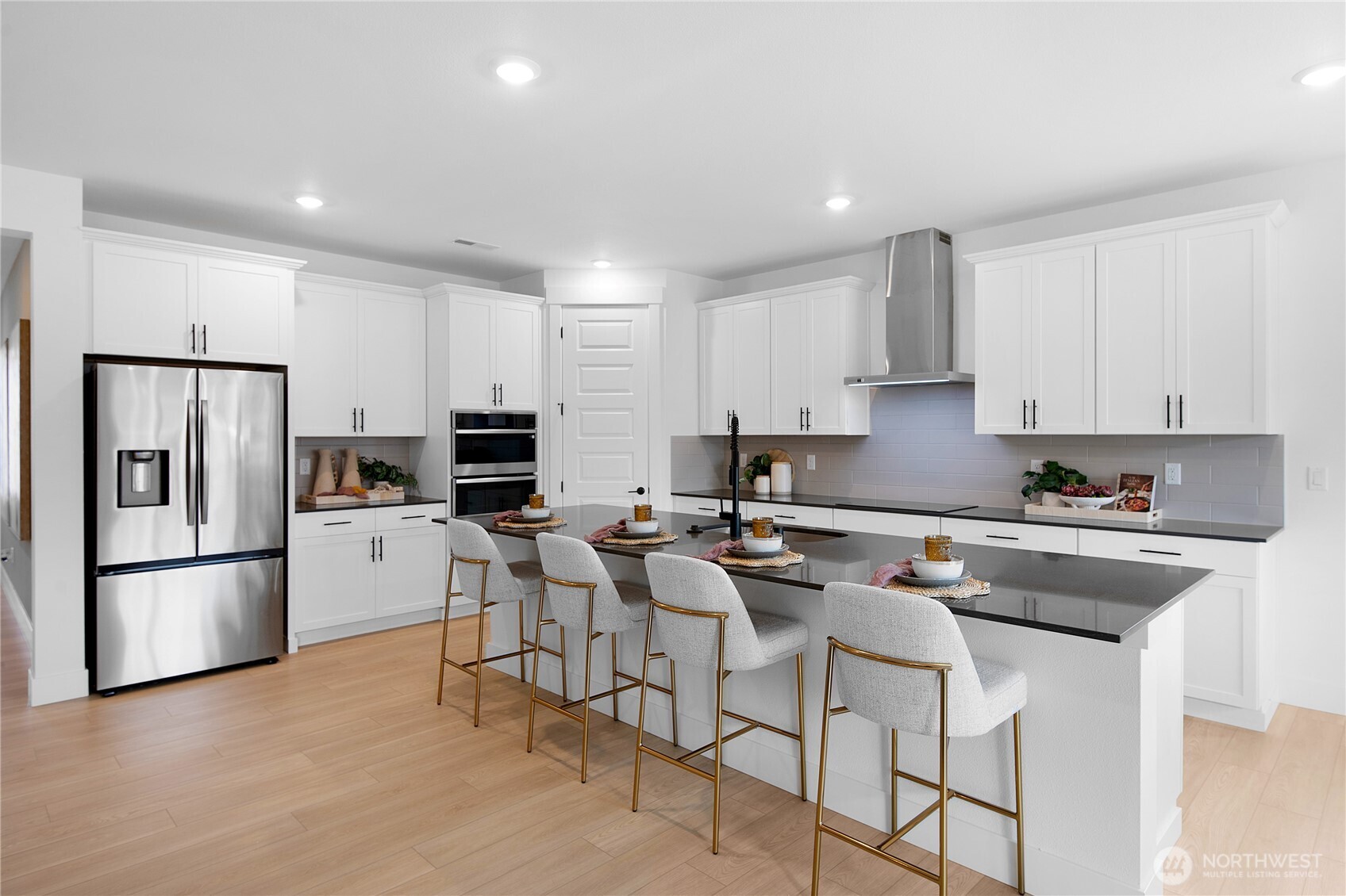 653 Gooseberry Place Sequim, WA 98382 - Photo 2 of 13 a kitchen with stainless steel appliances granite countertop a stove a sink a refrigerator and white cabinets