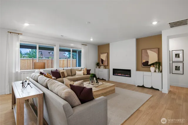 a living room with furniture and a wooden floor