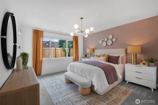 a bedroom with a bed a chandelier and dresser