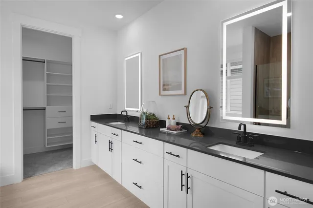 a bathroom with double sink and a mirror