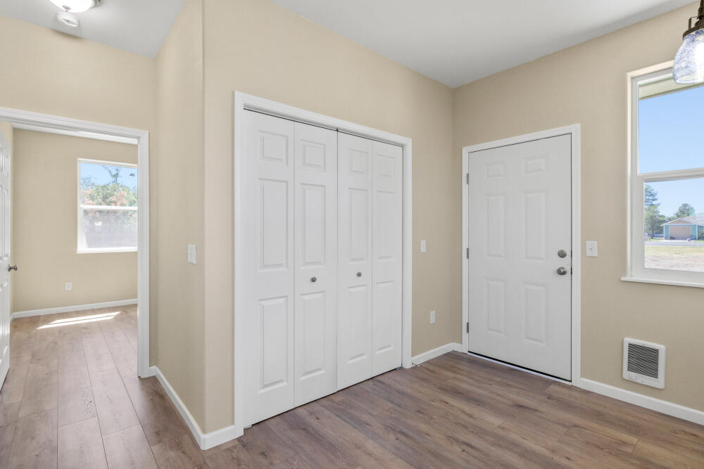 330 North Elm Street Merrill, OR 97633 - Photo 15 of 23 an empty room with wooden floor and windows