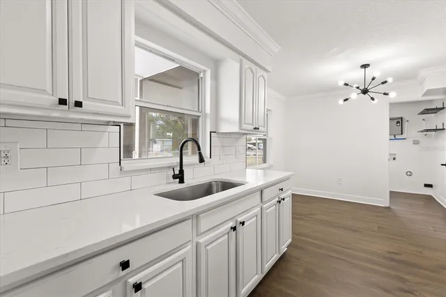 a kitchen with a sink and cabinets