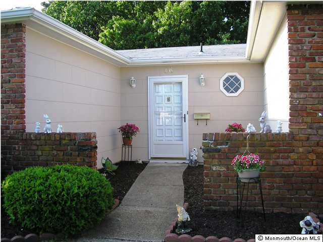 16 Phillips Road Brick, NJ 08724 - Photo 2 of 3 a front view of a house with a garden