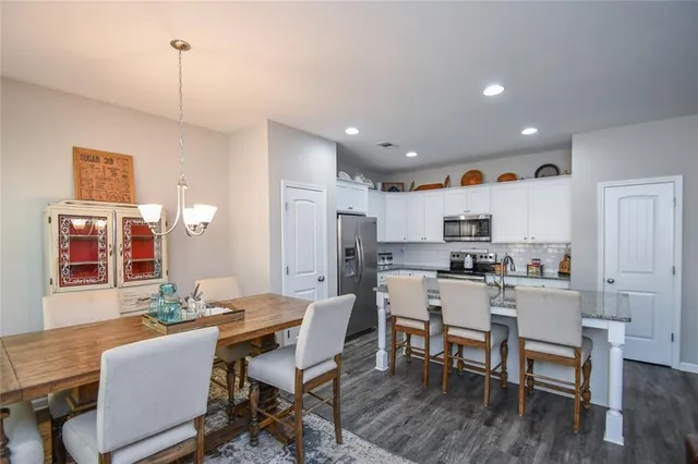 a kitchen with a sink a refrigerator and cabinets