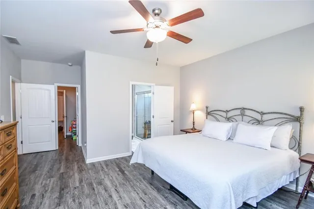 a bathroom with a granite countertop sink a toilet and a mirror