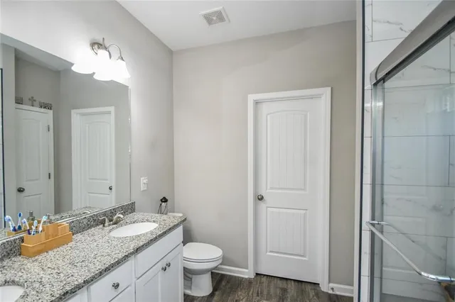 a en suite bathroom with a sink double vanity and a mirror