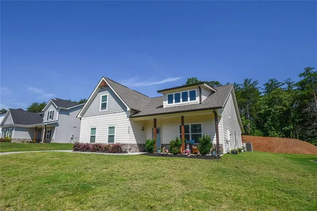 a view of a house with a yard and sitting area