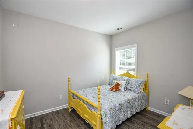 a bathroom with a granite countertop sink toilet and a mirror