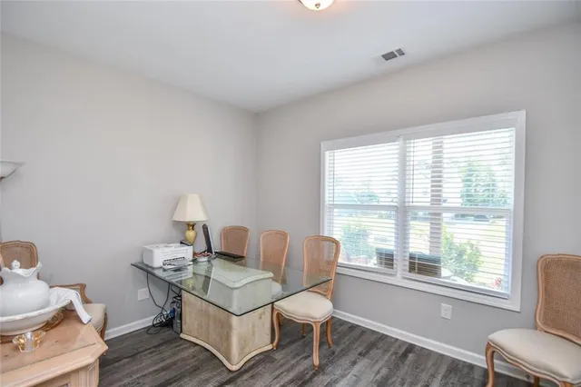 a view of a hallway with wooden floor and entryway