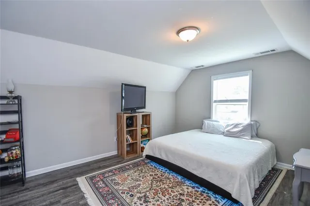 a garden with a table and chairs and potted plants