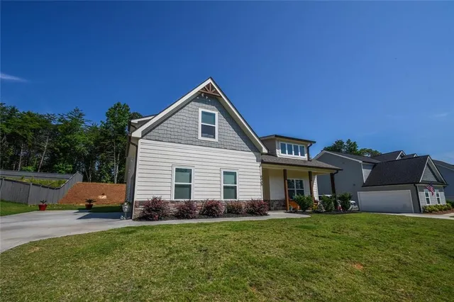 a front view of a house with a garden