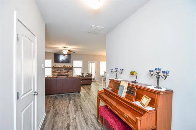 a living room with furniture a flat screen tv and a fireplace