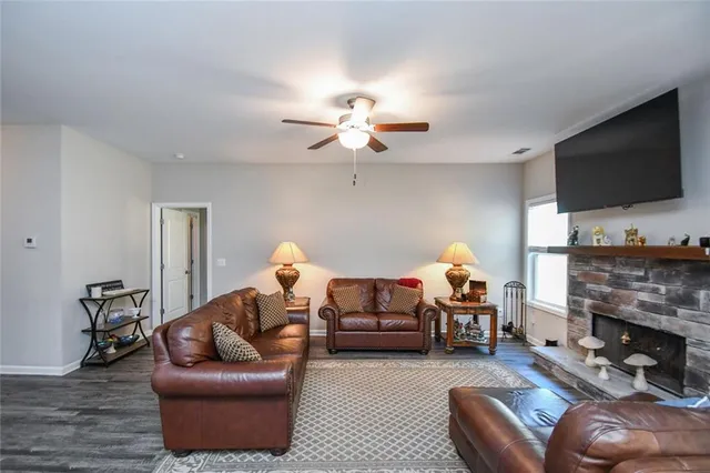 a living room with furniture kitchen view and a chandelier