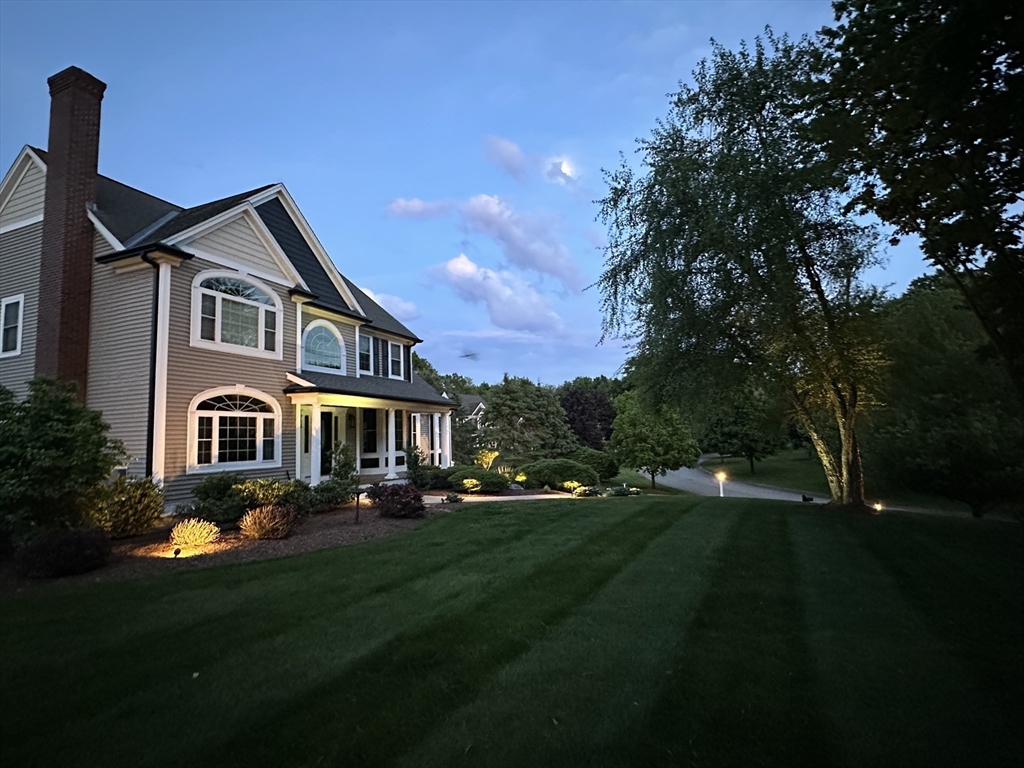 9 Round Farm Road Rehoboth, MA 02769 - Photo 6 of 41 a front view of a house with a garden and trees