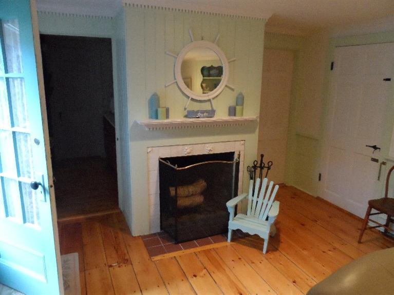 71 Gorham Road Harwich Port, MA 02646 - Photo 8 of 34 a living room with furniture and a fireplace