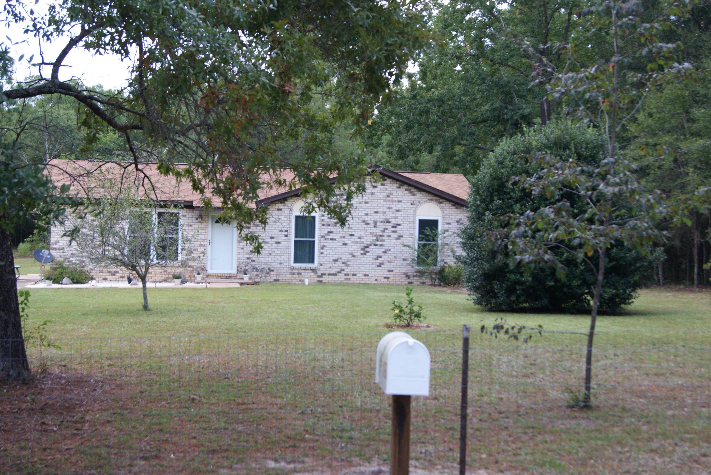 1137 Country Living Road Baker, FL 32531 - Photo 2 of 29 a front view of a house with a yard and tree