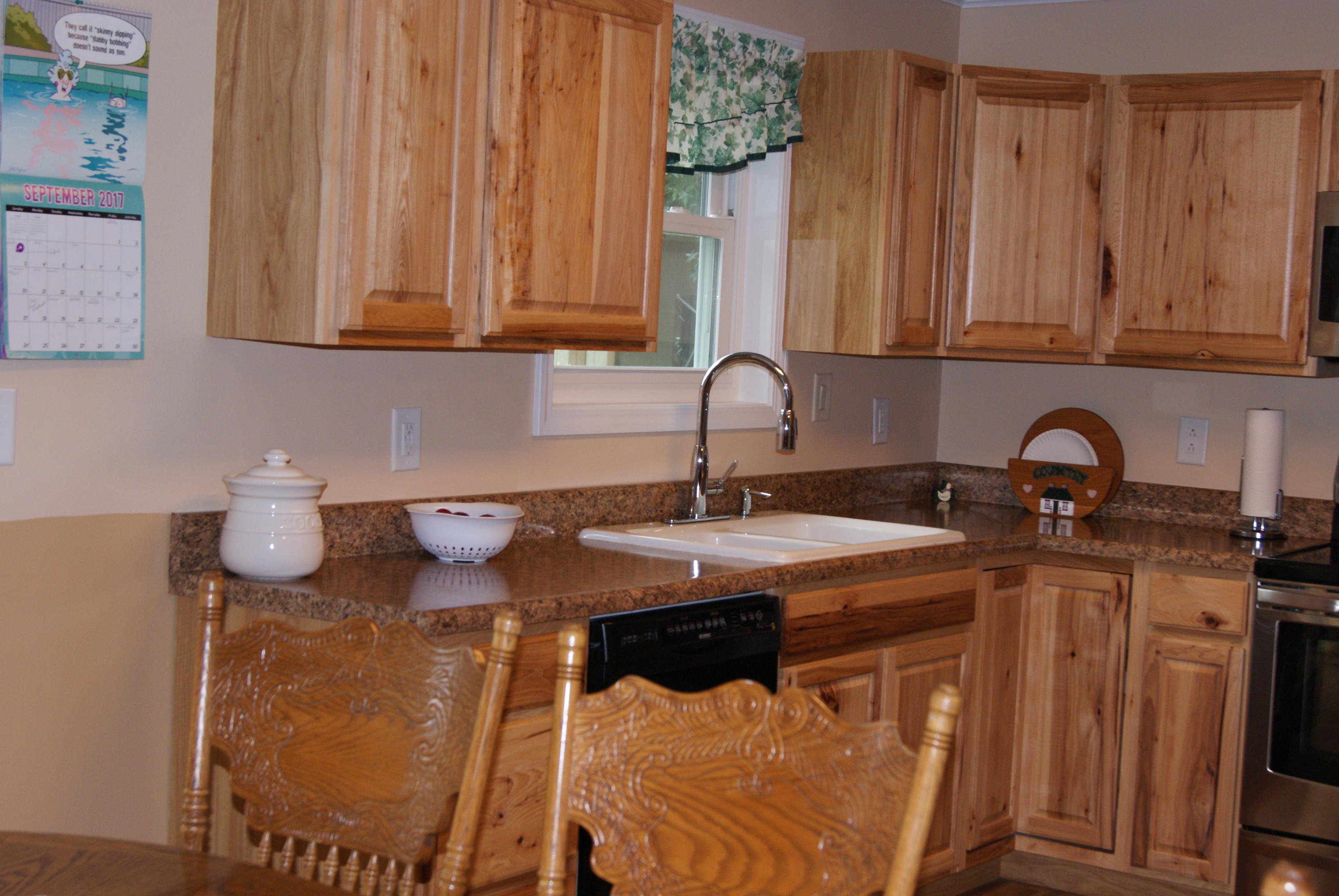 1137 Country Living Road Baker, FL 32531 - Photo 13 of 29 a kitchen with stainless steel appliances granite countertop a sink a stove and a wooden cabinets