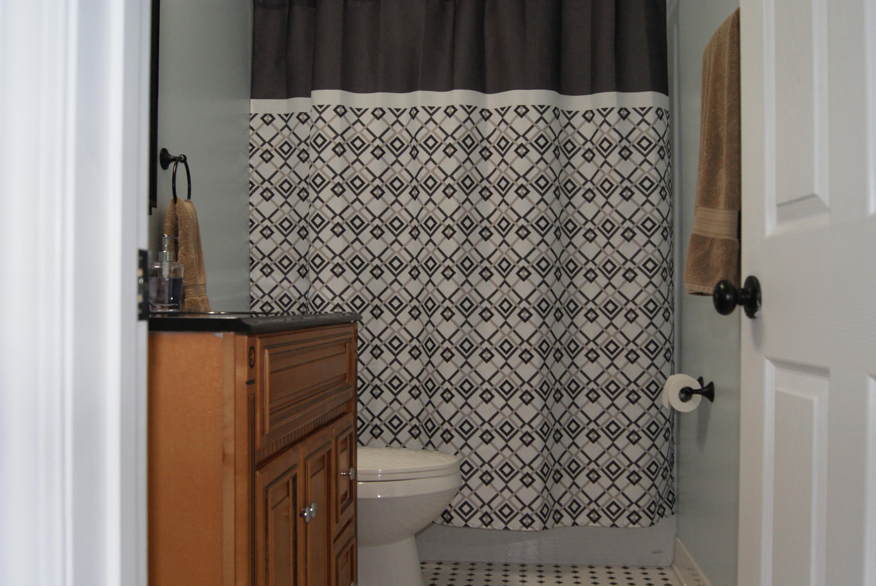 1137 Country Living Road Baker, FL 32531 - Photo 20 of 29 a bathroom with a shower curtain