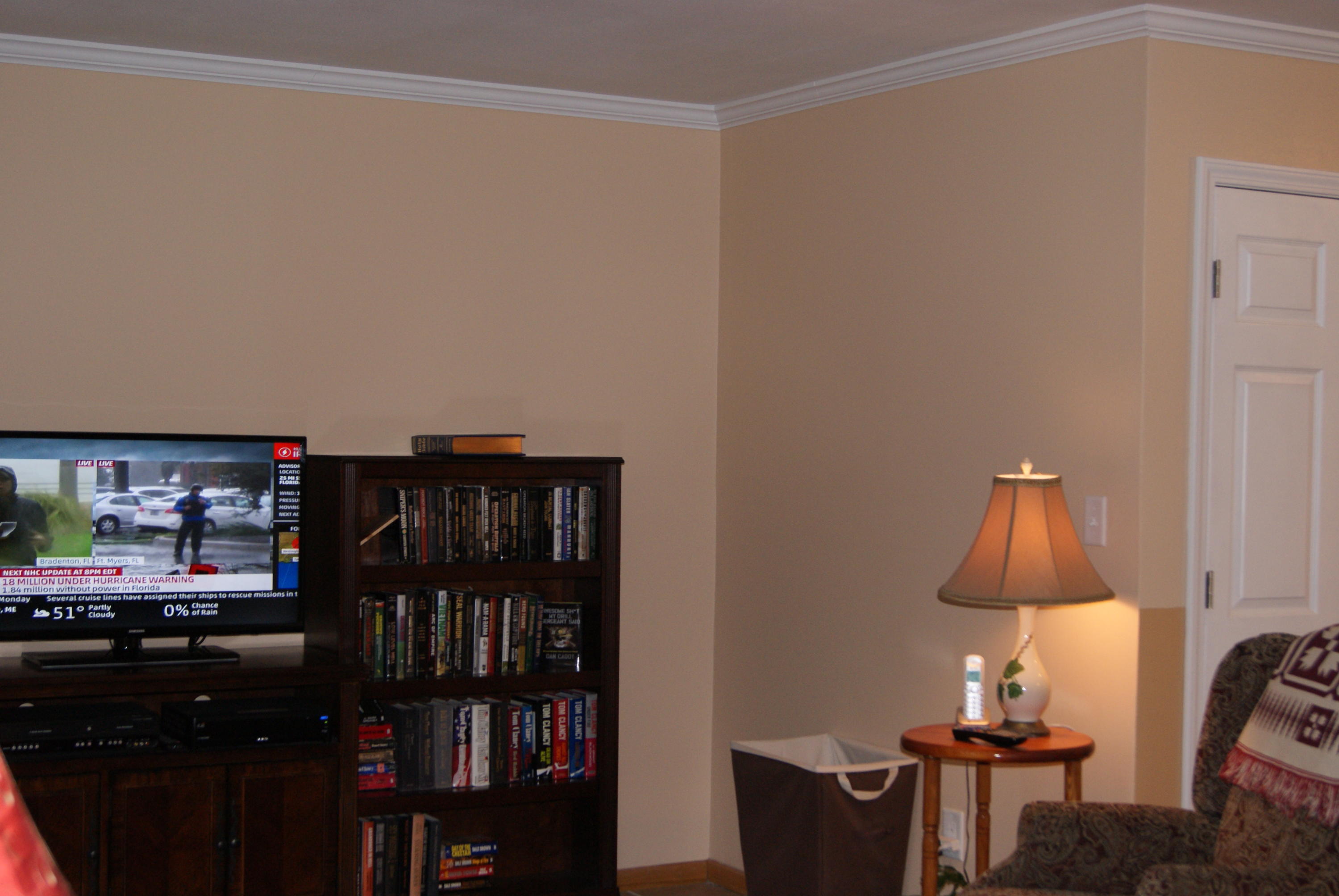 1137 Country Living Road Baker, FL 32531 - Photo 3 of 29 a room with a book shelf and a lamp on a table
