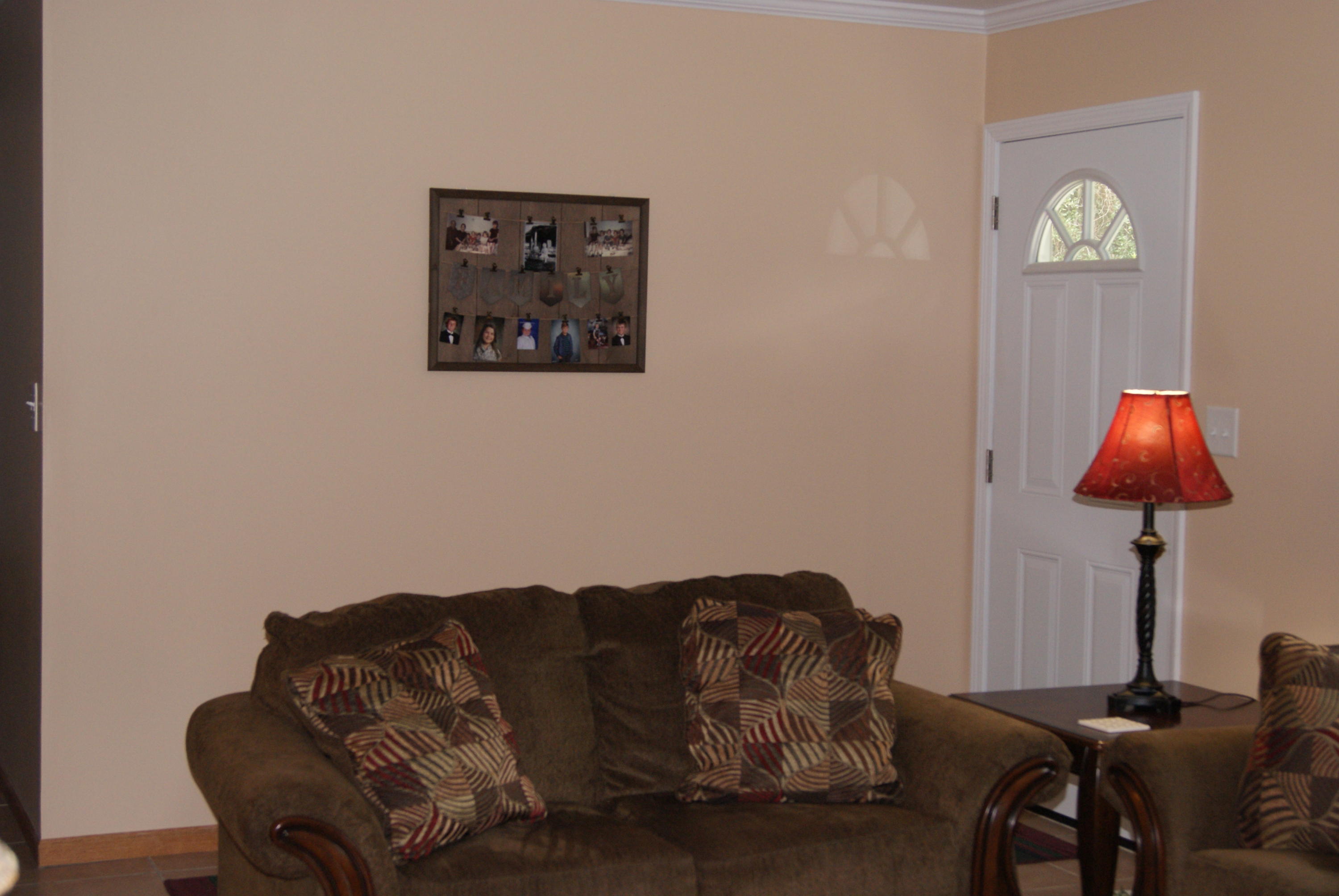 1137 Country Living Road Baker, FL 32531 - Photo 5 of 29 a living room with furniture a couch and a lamp on table