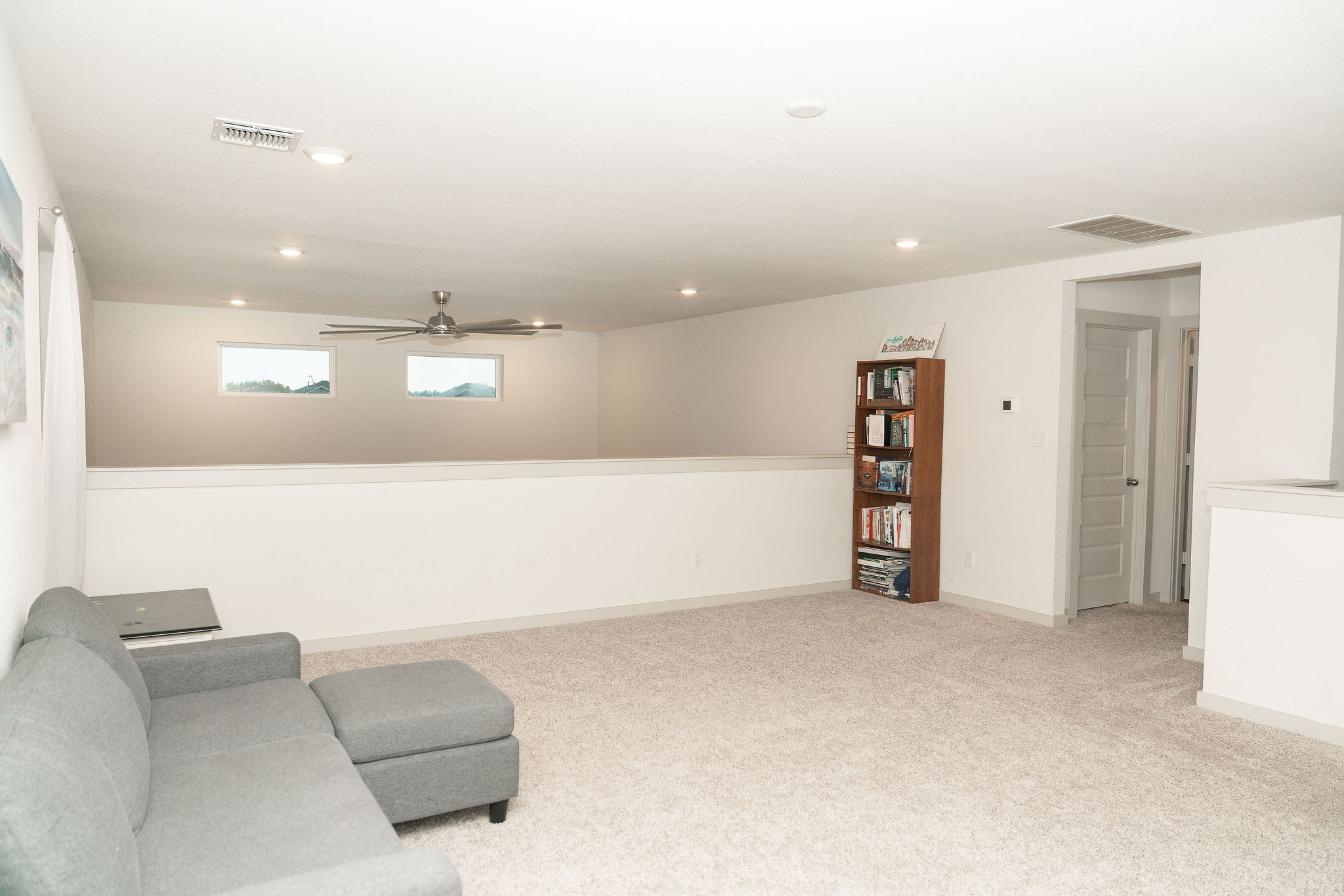 120 Wichita River Road Hutto, TX 78634 - Photo 13 of 31 A spacious carpeted loft area overlooks the lower level through high transom windows.