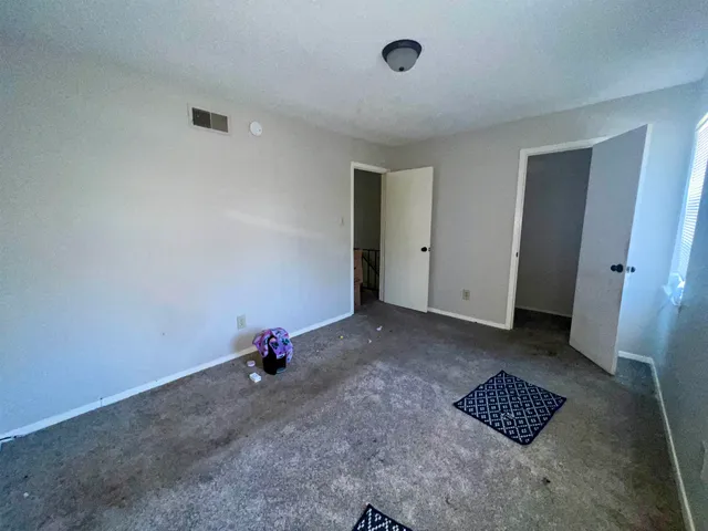a living room with furniture and a chair