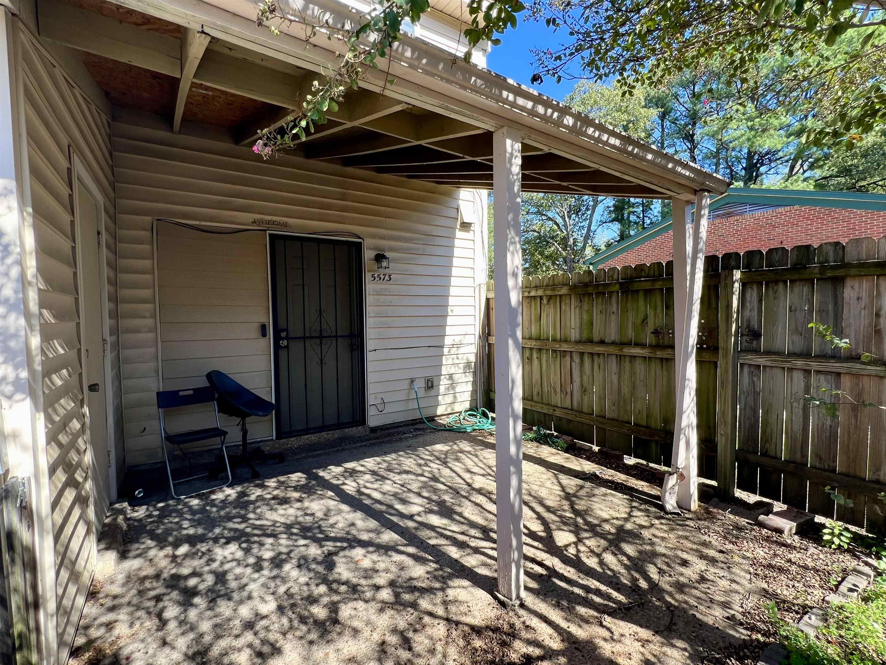 5573 Pleasant View Road, Unit 35 Memphis, TN 38134 - Photo 16 of 18 a backyard of a house with barbeque oven table and chairs