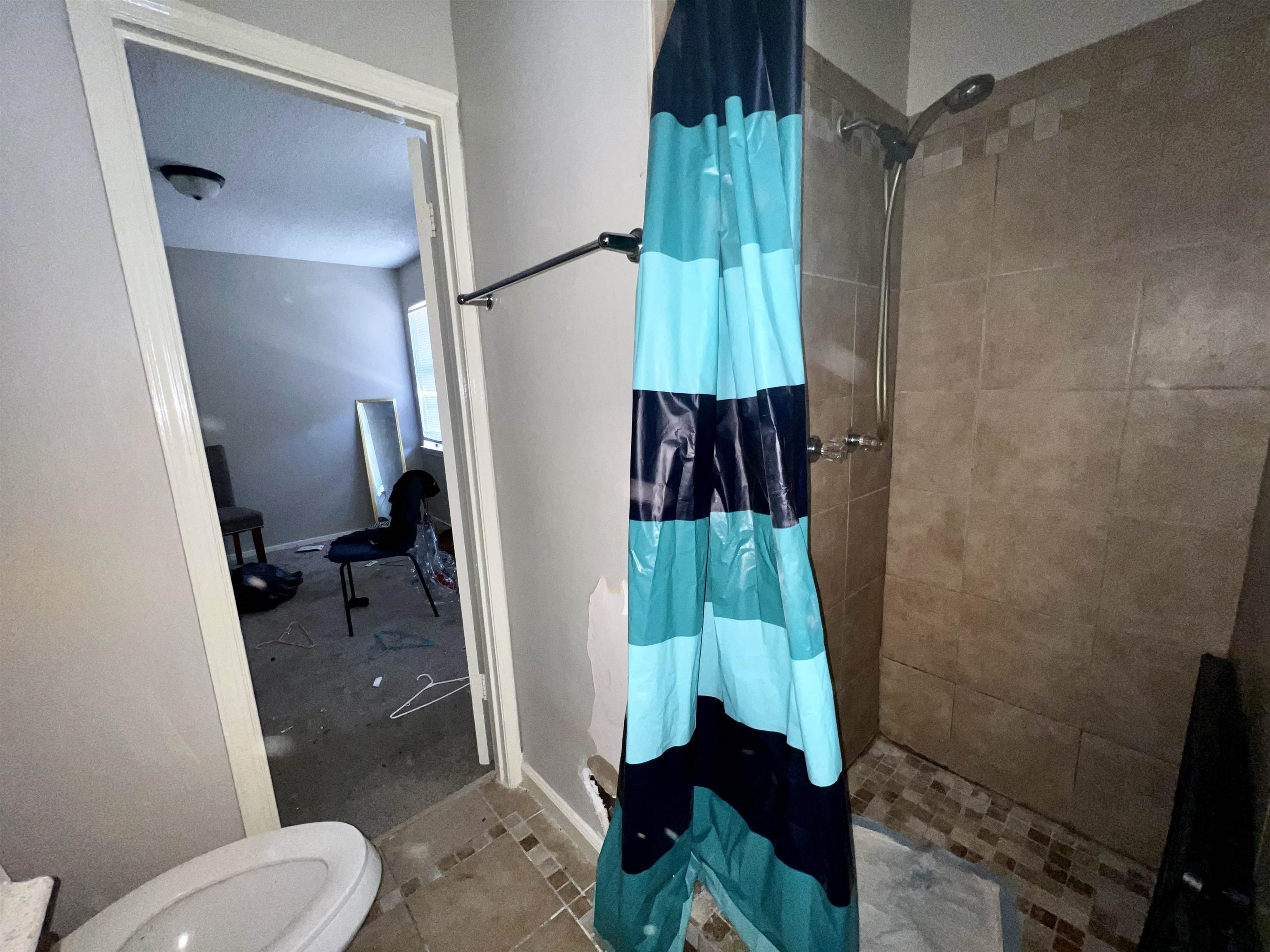 5573 Pleasant View Road, Unit 35 Memphis, TN 38134 - Photo 10 of 18 a bathroom with a toilet and a shower