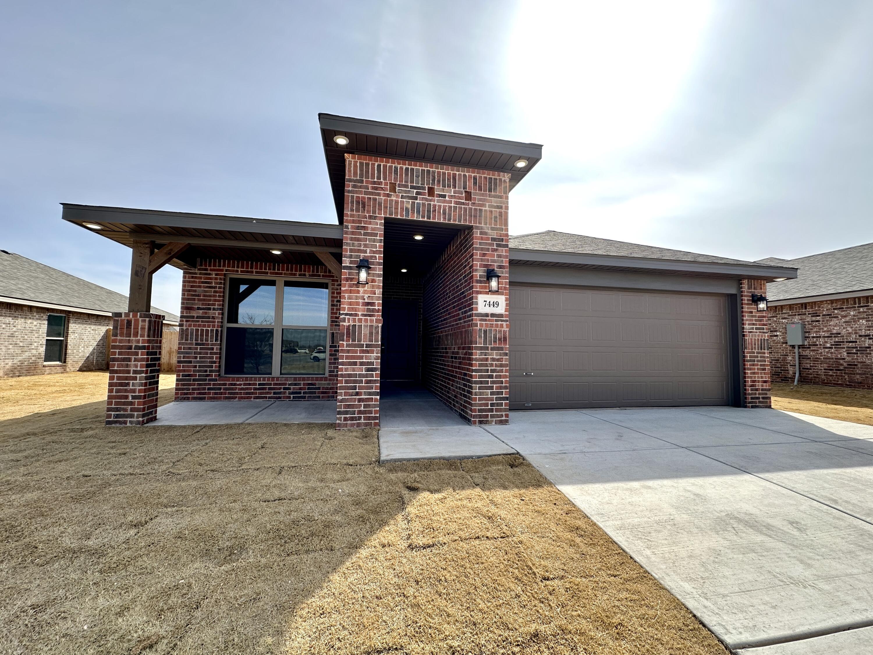 7449 28th Street Lubbock, TX 79407 - Photo 1 of 11 a view of a house with a porch and a fireplace