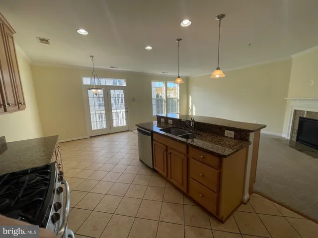 a kitchen with granite countertop a sink cabinets and window