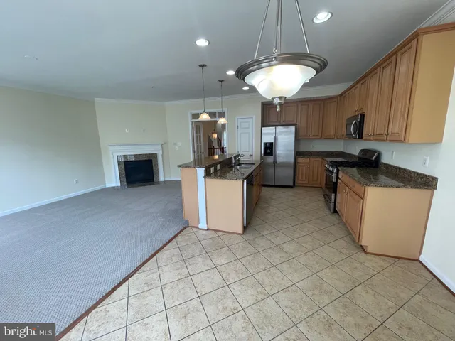 a view of an empty room with a fireplace