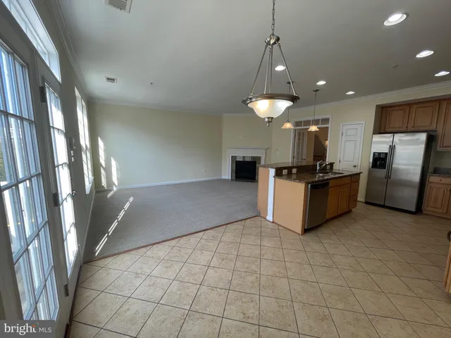 a view of a hallway with wooden floor and dining room
