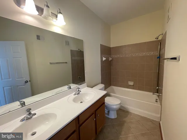 a view of a livingroom with a ceiling fan and window