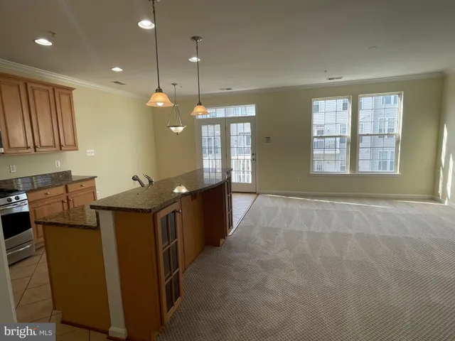 a view of a lake with a table and chairs under an umbrella
