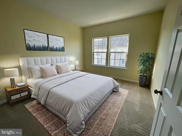 a view of an empty room with wooden floor and windows