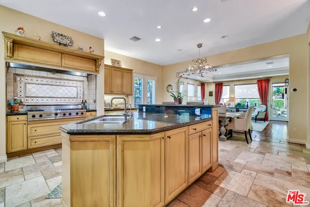 a kitchen with stainless steel appliances granite countertop a sink and cabinets