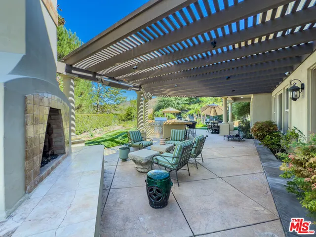 a view of a patio with chairs and plants