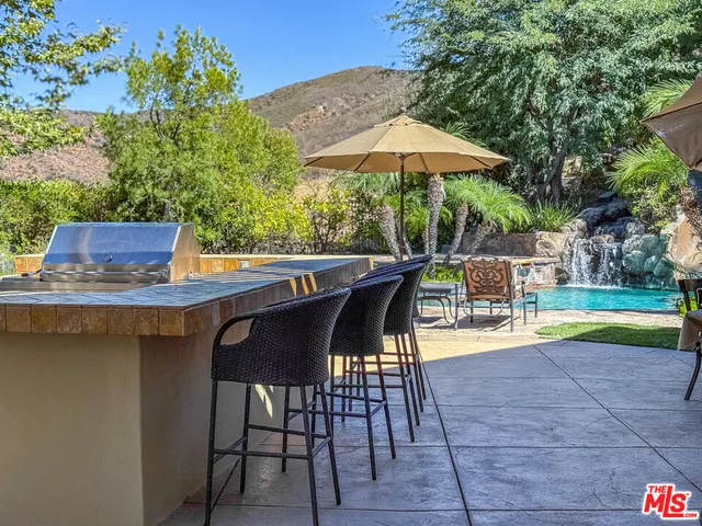 a view of backyard with seating space and trees