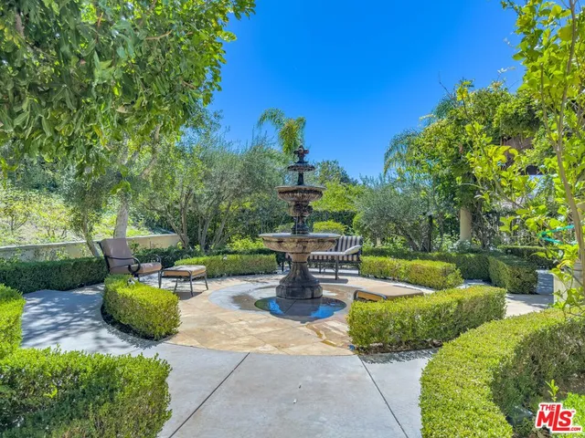 a view of a chair and fire pit in the backyard of a house
