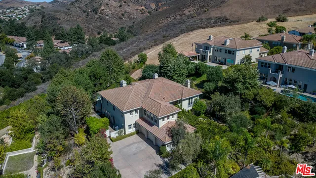 an aerial view of a house with yard and outdoor seating