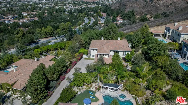 an aerial view of a house with yard